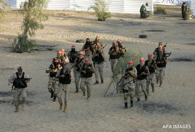 Palestinian militants of the National Resistance brigades, the armed wing of the Democratic Front for the Liberation of Palestine (DFLP), are seen during a graduation ceremony in Rafah, in the southern Gaza Strip, on Nov...