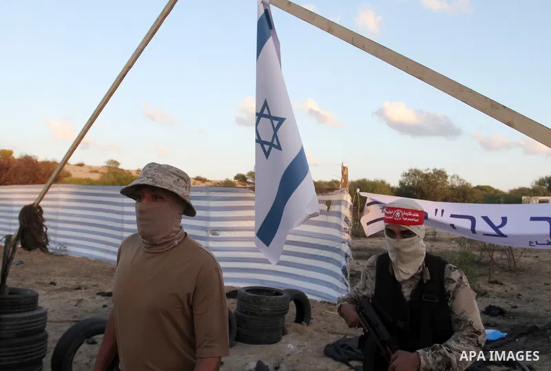 Palestinian militants of the National Resistance brigades, the armed wing of the Democratic Front for the Liberation of Palestine (DFLP), pretend to fight with mock Israeli forces during a graduation ceremony in Rafah, i...