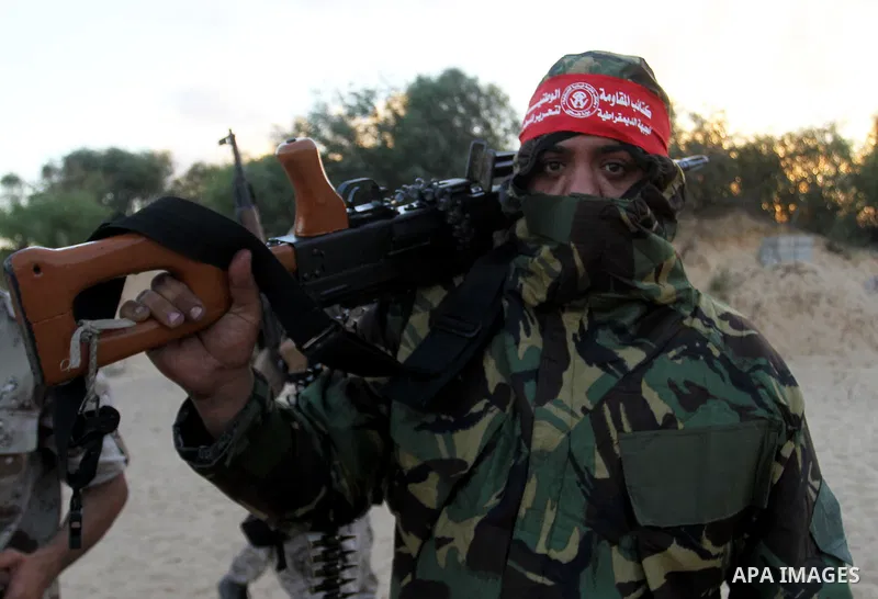 A Palestinian militant of the National Resistance brigades, the armed wing of the Democratic Front for the Liberation of Palestine (DFLP) takes a position during a graduation ceremony in Rafah in the southern Gaza Strip...