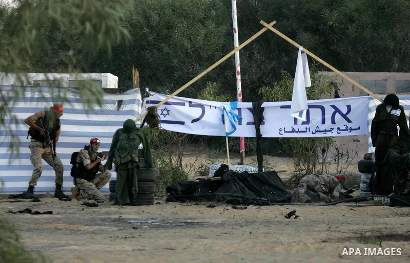 Palestinian militants of the National Resistance brigades, the armed wing of the Democratic Front for the Liberation of Palestine (DFLP), pretend to fight with mock Israeli forces during a graduation ceremony in Rafah, i...