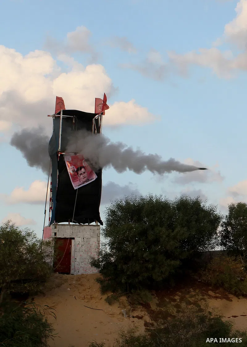 Palestinian militants of the National Resistance brigades, the armed wing of the Democratic Front for the Liberation of Palestine (DFLP), fire a rocket during a graduation ceremony in Rafah, in the southern Gaza Strip, o...