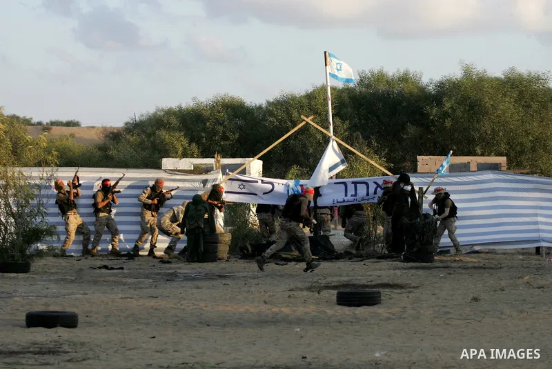 Palestinian militants of the National Resistance brigades, the armed wing of the Democratic Front for the Liberation of Palestine (DFLP), pretend to fight with mock Israeli forces during a graduation ceremony in Rafah, i...
