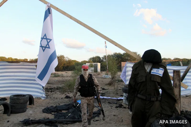 Palestinian militants of the National Resistance brigades, the armed wing of the Democratic Front for the Liberation of Palestine (DFLP), pretend to fight with mock Israeli forces during a graduation ceremony in Rafah, i...