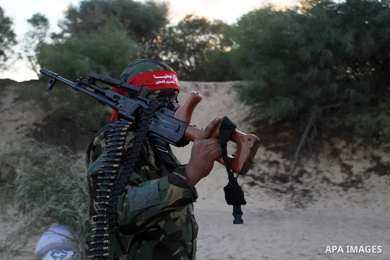 A Palestinian militant of the National Resistance brigades, the armed wing of the Democratic Front for the Liberation of Palestine (DFLP) takes a position during a graduation ceremony in Rafah in the southern Gaza Strip...