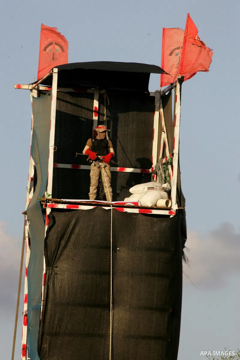 A Palestinian militant of the Democratic Front for the Liberation of Palestine (DFLP), stands guard on the tower during a graduation ceremony in Rafah, in the southern Gaza Strip, on November 4, 2016. Photo by Abed Rahim...