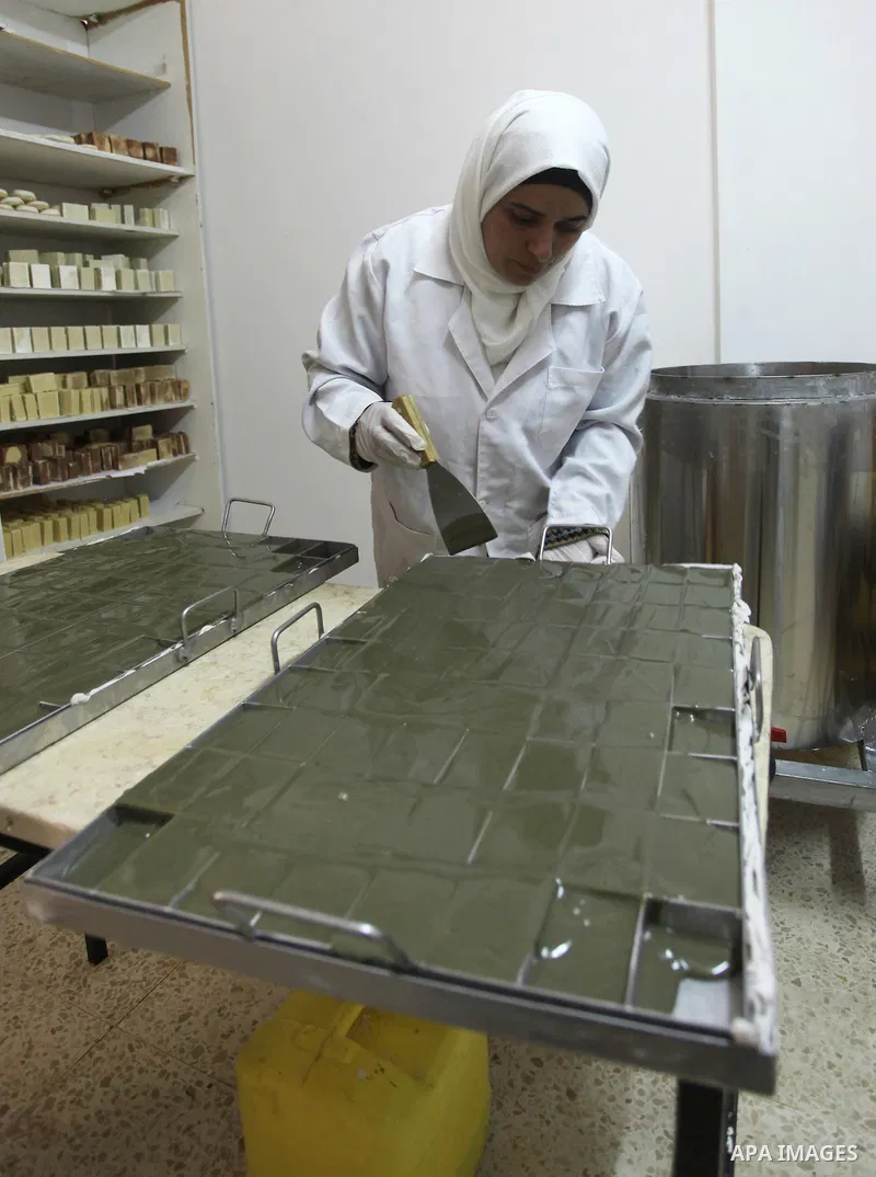 A Palestinian woman Howaida Abu yaqub ,40, prepares the natural soaps from natural raw materials olive oil, honey, goat's milk at her small workshop, in the West Bank city of Nablus, on November 7, 2016. Photo by Nedal E...