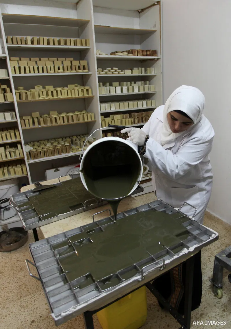 A Palestinian woman Howaida Abu yaqub ,40, prepares the natural soaps from natural raw materials olive oil, honey, goat's milk at her small workshop, in the West Bank city of Nablus, on November 7, 2016. Photo by Nedal E...
