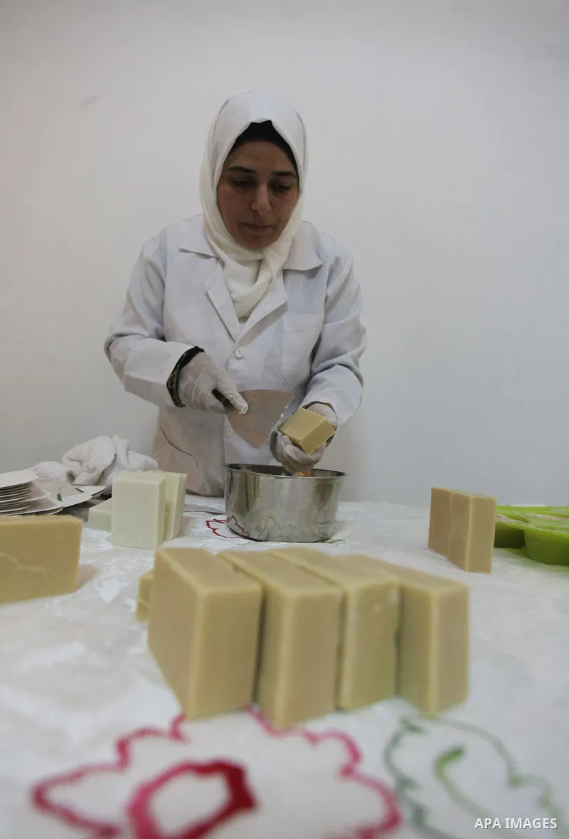 A Palestinian woman Howaida Abu yaqub ,40, prepares the natural soaps from natural raw materials olive oil, honey, goat's milk at her small workshop, in the West Bank city of Nablus, on November 7, 2016. Photo by Nedal E...