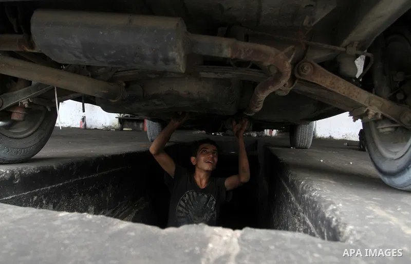 A Palestinian boy works at a mechanic shop in Rafah in the southern Gaza strip, on November 7, 2016. Photo by Abed Rahim Khatib