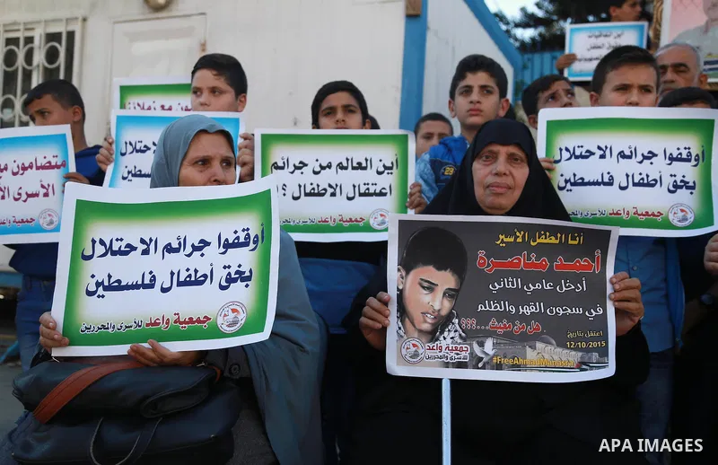 Palestinian boys take part in a protest to solidarity with jailed Palestinian Ahmad Manasrah was sentenced to 12 years in prison for attempted murder, in Gaza city, November 8, 2016. Photo by Hassan Jedi
