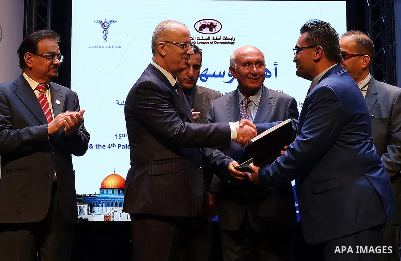 Palestinian Prime Minister Rami Hamdallah attends the opening of 15th international conference of Skin doctors, in the West Bank city of Ramallah, on Nov. 08, 2016. Photo by Prime Minister Office