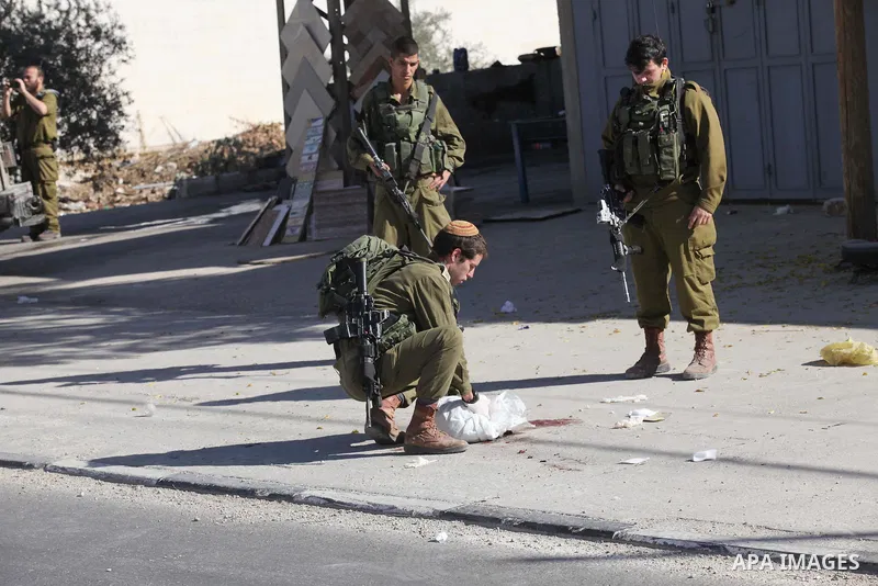 Israeli security forces search the scene where the Israeli military said a Palestinian stabbed a soldier with screwdriver before he was shot, in the West Bank village of Hawara near Nablus, November 9, 2016. Photo by Ned...