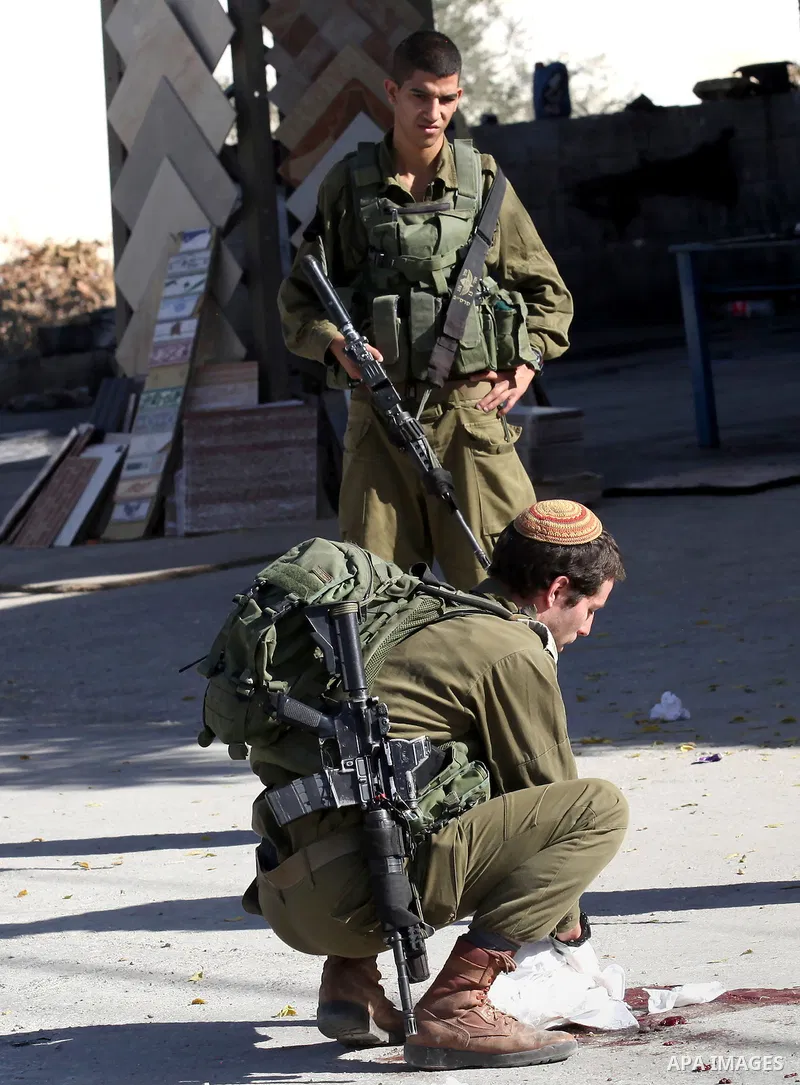Israeli security forces search the scene where the Israeli military said a Palestinian stabbed a soldier with screwdriver before he was shot, in the West Bank village of Hawara near Nablus, November 9, 2016. Photo by Ned...