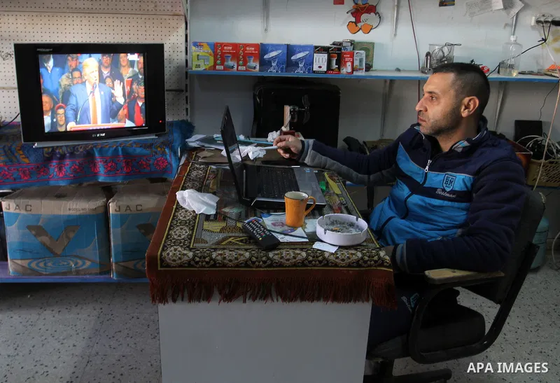 A Palestinian man watches Donald Trump's victory speech on TV in Rahaf in the southern Gaza strip, on November 9, 2016. U.S. Republican Donald Trump has been elected the 45th president of the United States after defeated...