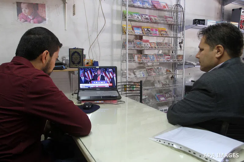 Palestinians watch Donald Trump's victory speech on TV in Rahaf in the southern Gaza strip, on November 9, 2016. U.S. Republican Donald Trump has been elected the 45th president of the United States after defeated his De...