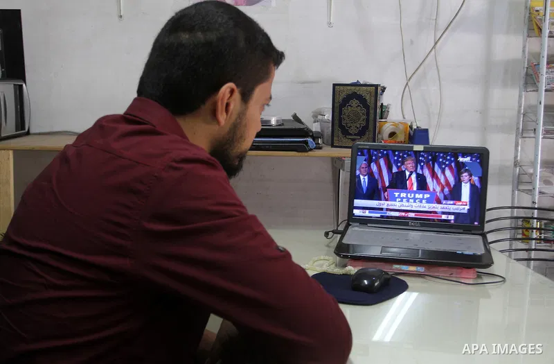 A Palestinian man watches Donald Trump's victory speech on TV in Rahaf in the southern Gaza strip, on November 9, 2016. U.S. Republican Donald Trump has been elected the 45th president of the United States after defeated...