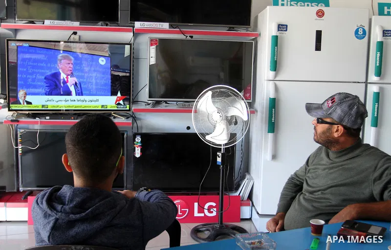 Palestinians watch Donald Trump's victory speech on TV in Rahaf in the southern Gaza strip, on November 9, 2016. U.S. Republican Donald Trump has been elected the 45th president of the United States after defeated his De...