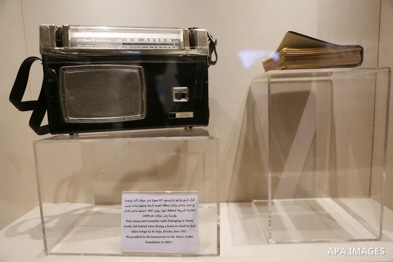 A picture shows Holy Quran and transistor radio belonging to Yasser arafat at the late Palestinian leader Yasser Arafat's Museum in the West Bank city of Ramallah on November 9, 2016. The Yasser Arafat Museum opened in R...