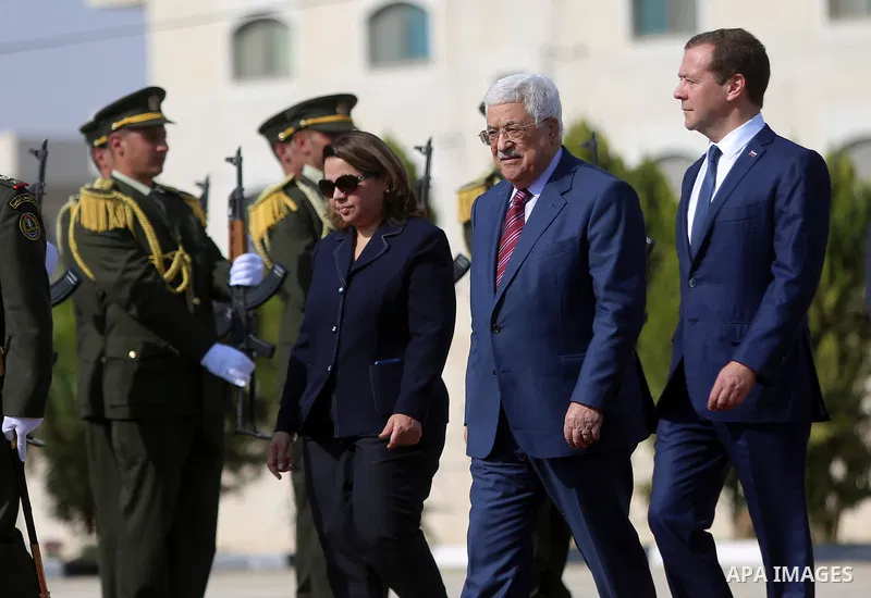 Palestinian President Mahmud Abbas and Russian Prime Minister Dmitry Medvedev review the honour guard ahead of a meeting in the West Bank city of Jericho, on November 11, 2016. Photo by Shadi Hatem