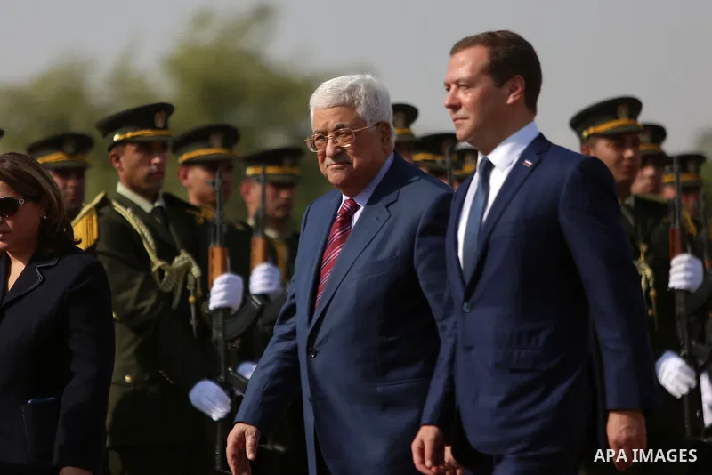 Palestinian President Mahmud Abbas and Russian Prime Minister Dmitry Medvedev review the honour guard ahead of a meeting in the West Bank city of Jericho, on November 11, 2016. Photo by Shadi Hatem