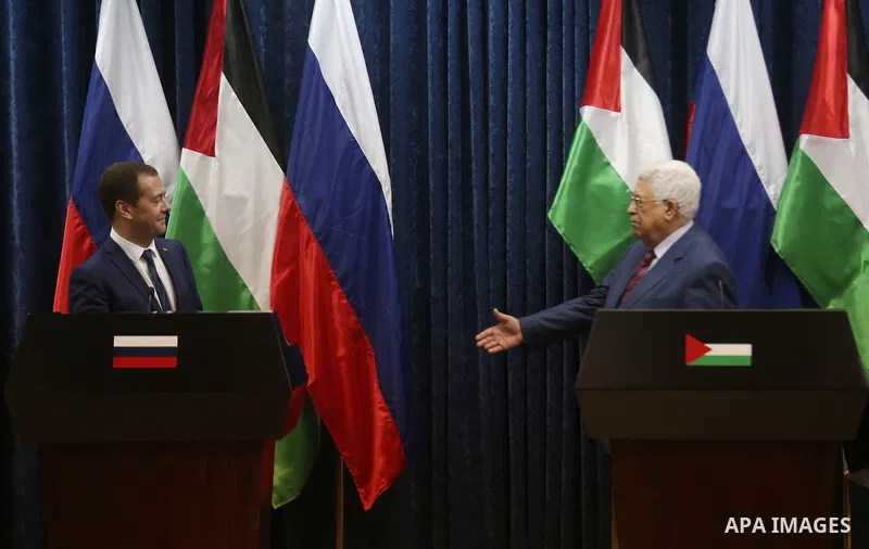 Palestinian President Mahmoud Abbas shake hands with Russian Prime Minister Dmitry Medvedev after a joint news conference in the West Bank city of Jericho November 11, 2016. Photo by Shadi Hatem