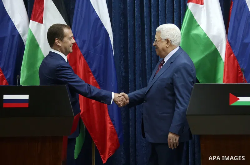Palestinian President Mahmoud Abbas shake hands with Russian Prime Minister Dmitry Medvedev after a joint news conference in the West Bank city of Jericho November 11, 2016. Photo by Shadi Hatem