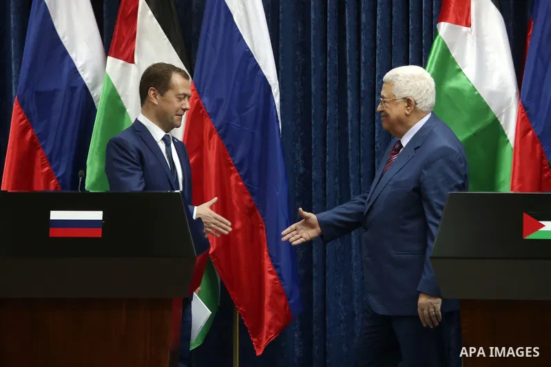 Palestinian President Mahmoud Abbas shake hands with Russian Prime Minister Dmitry Medvedev after a joint news conference in the West Bank city of Jericho November 11, 2016. Photo by Shadi Hatem