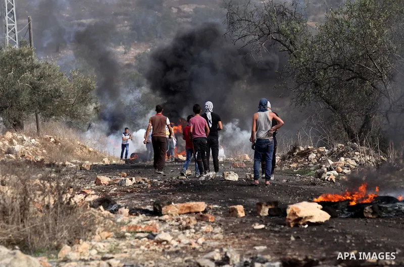Palestinian protesters hurl stones towards Israeli security forces during clashes following a demonstration against the expropriation of Palestinian land by Israel on November 11, 2016 in the village of Kfar Qaddum, near...