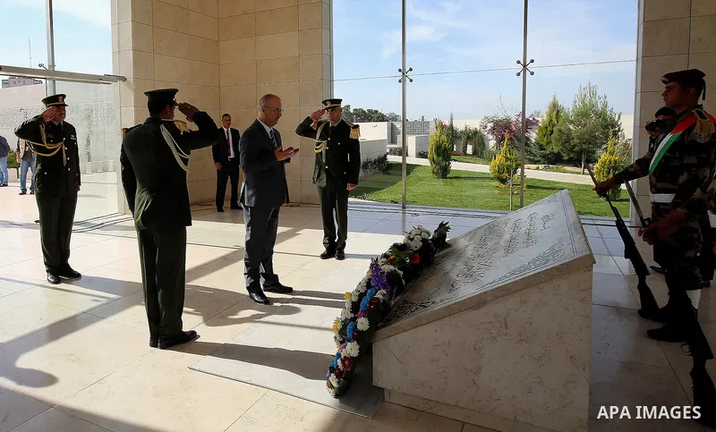 Palestinian Prime Minister Rami Hamdallah lays a wreath on the grave of late Palestinian leader Yasser Arafat, to mark the 12th anniversary of the former leader's death, on November 11, 2016 in the West Bank city of Rama...