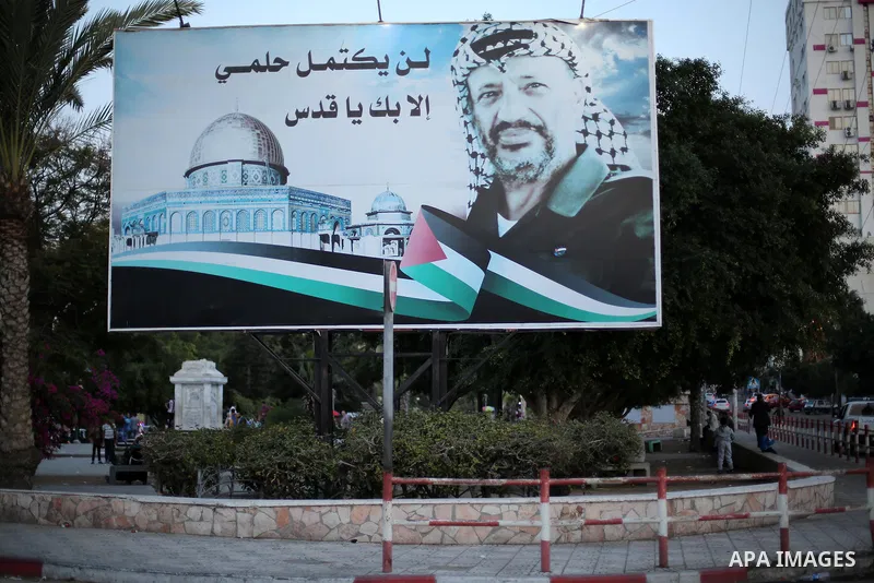 A Picture taken on November 11, 2016 shows a poster of the late Palestinian leader Yasser Arafat, on the 12 anniversary of his death in Gaza city. Photo by Mohammed Asad