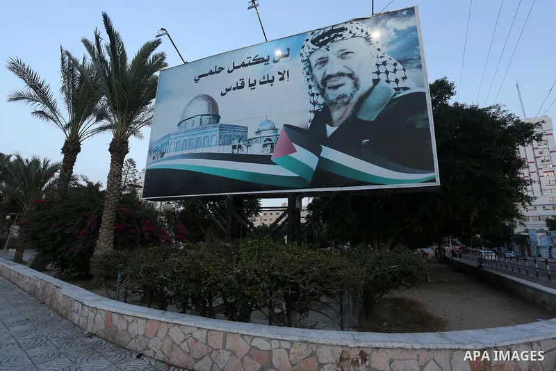 A Picture taken on November 11, 2016 shows a poster of the late Palestinian leader Yasser Arafat, on the 12 anniversary of his death in Gaza city. Photo by Mohammed Asad