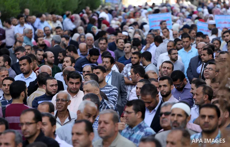 Palestinians hold banners during a protest against the UNRWA decision to reduce of the aid in front of the headquarters United Nations Relief and Works Agency (UNRWA), in Gaza city, on Nov. 14, 2016. Photo by Mohammed As...