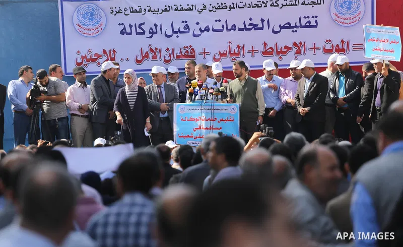 Palestinians hold banners during a protest against the UNRWA decision to reduce of the aid in front of the headquarters United Nations Relief and Works Agency (UNRWA), in Gaza city, on Nov. 14, 2016. Photo by Mohammed As...