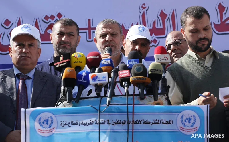 Palestinians hold banners during a protest against the UNRWA decision to reduce of the aid in front of the headquarters United Nations Relief and Works Agency (UNRWA), in Gaza city, on Nov. 14, 2016. Photo by Mohammed As...