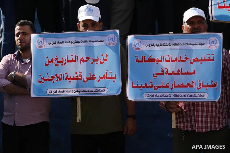 Palestinians hold banners during a protest against the UNRWA decision to reduce of the aid in front of the headquarters United Nations Relief and Works Agency (UNRWA), in Gaza city, on Nov. 14, 2016. Photo by Mohammed As...