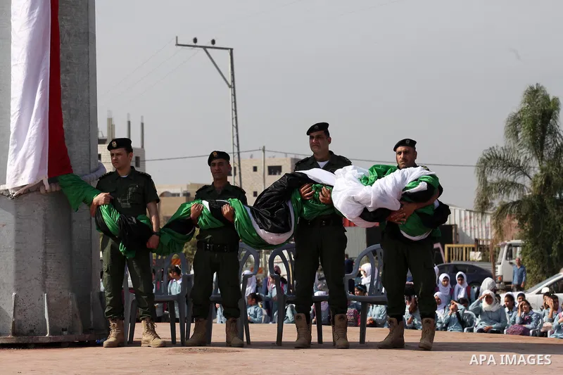 Palestinian security personnel take part in a rally to raise a Palestinian flag marking the Palestinian Declaration of Independence in 1988, in the West Bank city of Tulkarm November 14, 2016. Photo by Nedal Eshtayah
