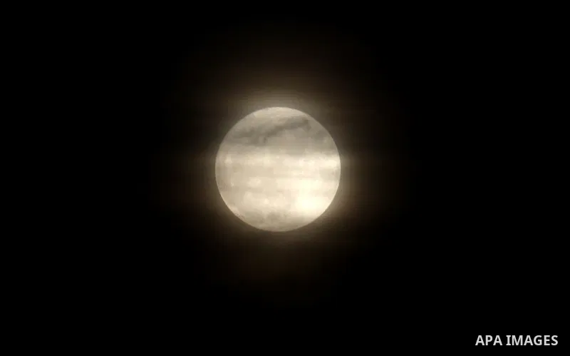 The moon is partly covered by clouds as it rises over the West Bank city of Nablus on November 14, 2016. The moon will be the closest to Earth since 1948 at a distance of 356,509 kilometres (221,524 miles), creating what...