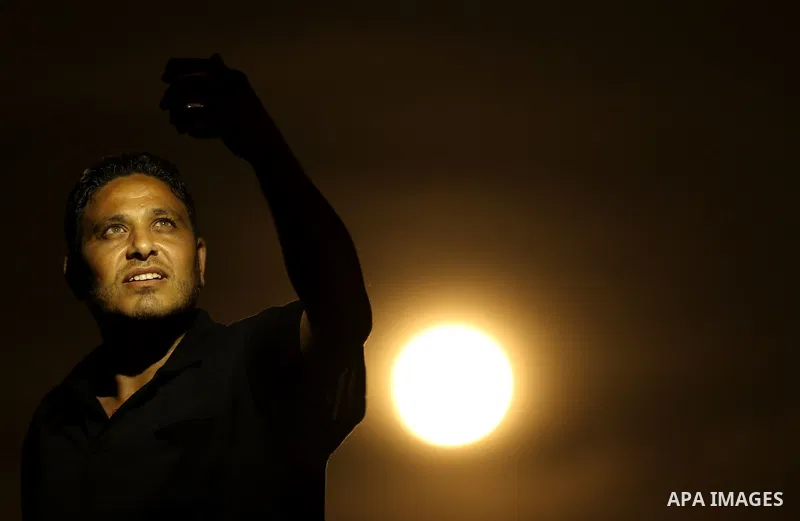 A Palestinian man takes a selife as the 'Supermoon' rises over Gaza city on November 14, 2016. The moon will be the closest to Earth since 1948 at a distance of 356,509 kilometres (221,524 miles), creating what NASA desc...