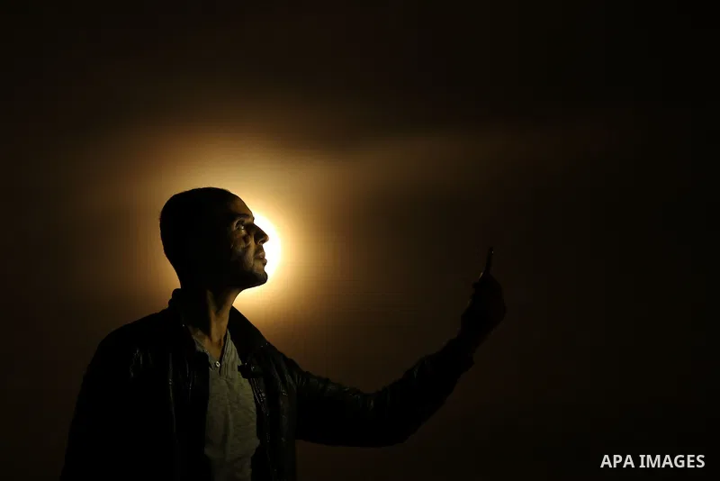 A Palestinian man takes a selife as the 'Supermoon' rises over Gaza city on November 14, 2016. The moon will be the closest to Earth since 1948 at a distance of 356,509 kilometres (221,524 miles), creating what NASA desc...