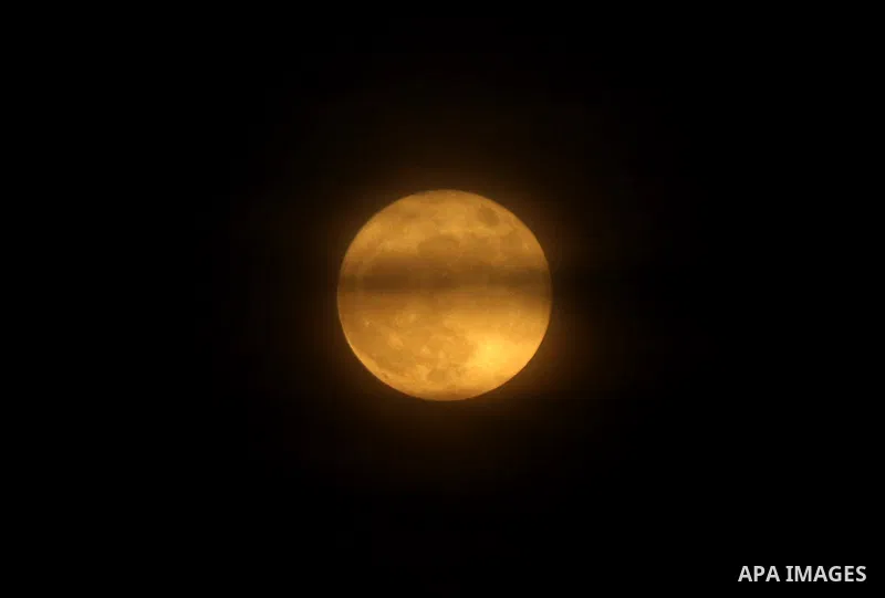 The moon is partly covered by clouds as it rises over Gaza city on November 14, 2016. The moon will be the closest to Earth since 1948 at a distance of 356,509 kilometres (221,524 miles), creating what NASA described as...