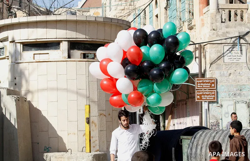 Palestinian scouts take part in a march marking the Palestinian national day of independence, in the West Bank city of Hebron on November 15, 2016. Photo by Wisam Hashlamoun