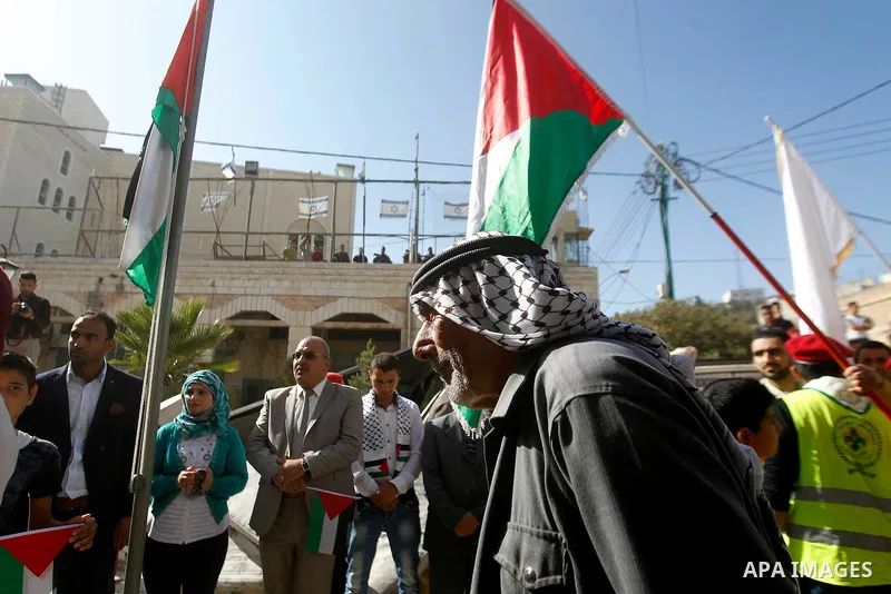 Palestinian scouts take part in a march marking the Palestinian national day of independence, in the West Bank city of Hebron on November 15, 2016. Photo by Wisam Hashlamoun
