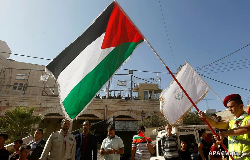 Palestinian scouts take part in a march marking the Palestinian national day of independence, in the West Bank city of Hebron on November 15, 2016. Photo by Wisam Hashlamoun