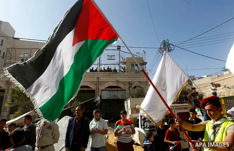 Palestinian scouts take part in a march marking the Palestinian national day of independence, in the West Bank city of Hebron on November 15, 2016. Photo by Wisam Hashlamoun