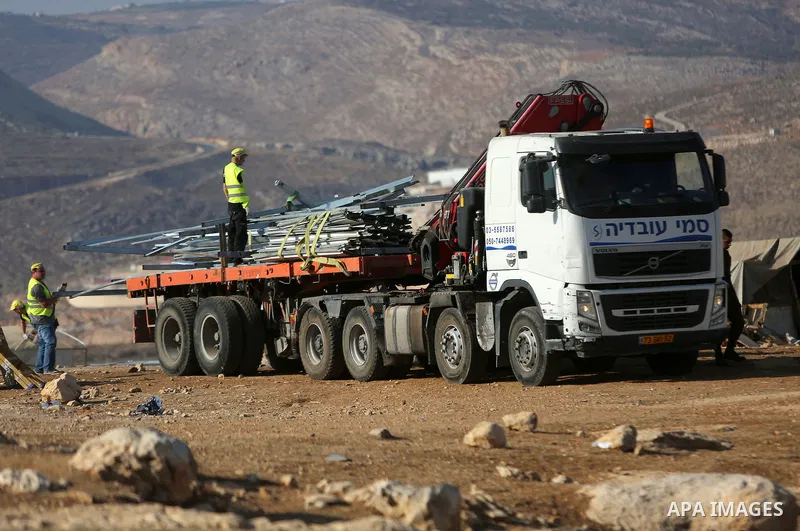 Israeli security forces confiscate barracks in the Palestinian Bedouin residential area after Israeli authorities said it was built without a permit in the West Bank village of Jab'a, north east of Jerusalem on Nov. 15,...