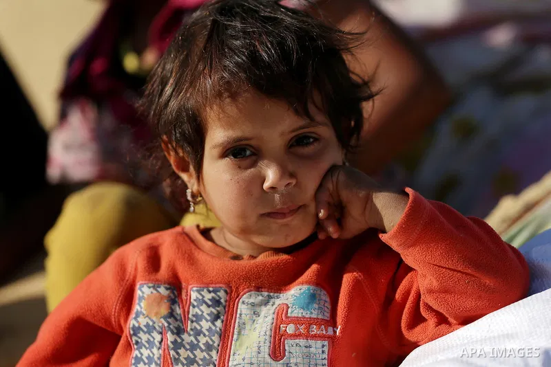A Palestinian Bedouin girl looks on as Israeli security forces confiscate barracks in the Bedouin residential area after Israeli authorities said it was built without a permit in the West Bank village of Jab'a, north eas...