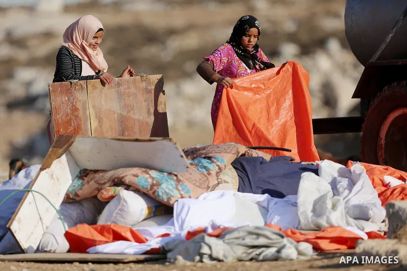 Palestinian Bedouins collect their belongings as Israeli security forces confiscate barracks in the Bedouin residential area after Israeli authorities said it was built without a permit in the West Bank village of Jab'a,...