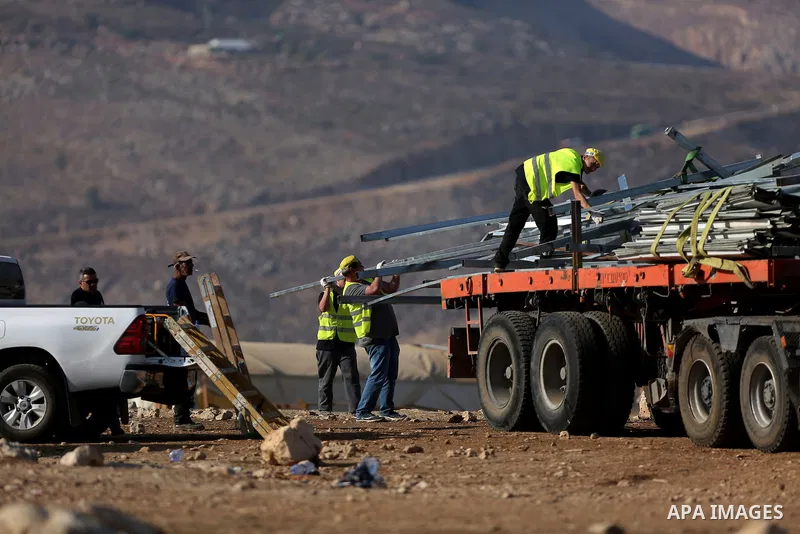 Israeli security forces confiscate barracks in the Palestinian Bedouin residential area after Israeli authorities said it was built without a permit in the West Bank village of Jab'a, north east of Jerusalem on Nov. 15,...