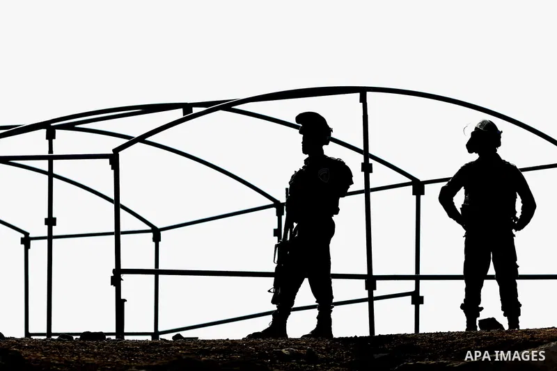 Israeli security forces confiscate barracks in the Palestinian Bedouin residential area after Israeli authorities said it was built without a permit in the West Bank village of Jab'a, north east of Jerusalem on Nov. 15,...