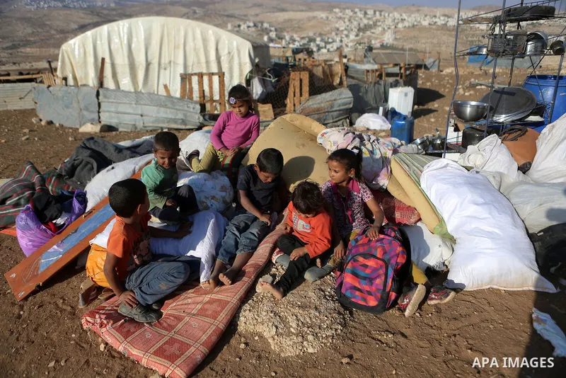 Palestinian Bedouins collect their belongings as Israeli security forces confiscate barracks in the Bedouin residential area after Israeli authorities said it was built without a permit in the West Bank village of Jab'a,...